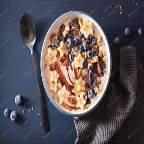 healthy banana smoothie bowl with blueberry chocolate walnuts